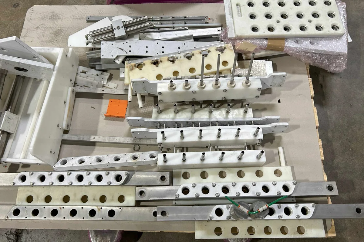 Meheen format-change parts laid out on a pallet in the workshop